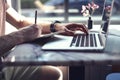 Close-up of manÃ¢â¬â¢s hands on laptop. Guy using computer and smartphone sitting in cafe having coffee Royalty Free Stock Photo